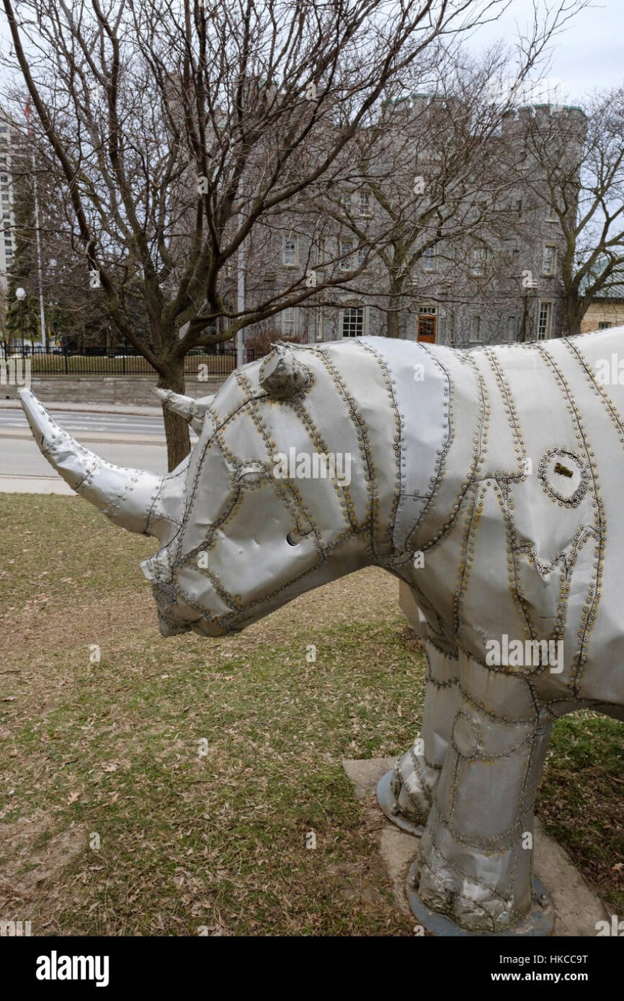 Picture of: Metal sculpture of a white rhino by artist Tom Benner in front of